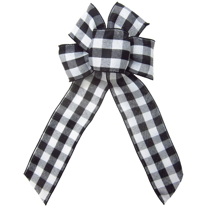 May include: A black and white checkered bow with a center loop. The bow is made of a soft, textured fabric.