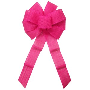 May include: A large, bright pink burlap bow with two long tails. The bow is tied in a classic, symmetrical style.