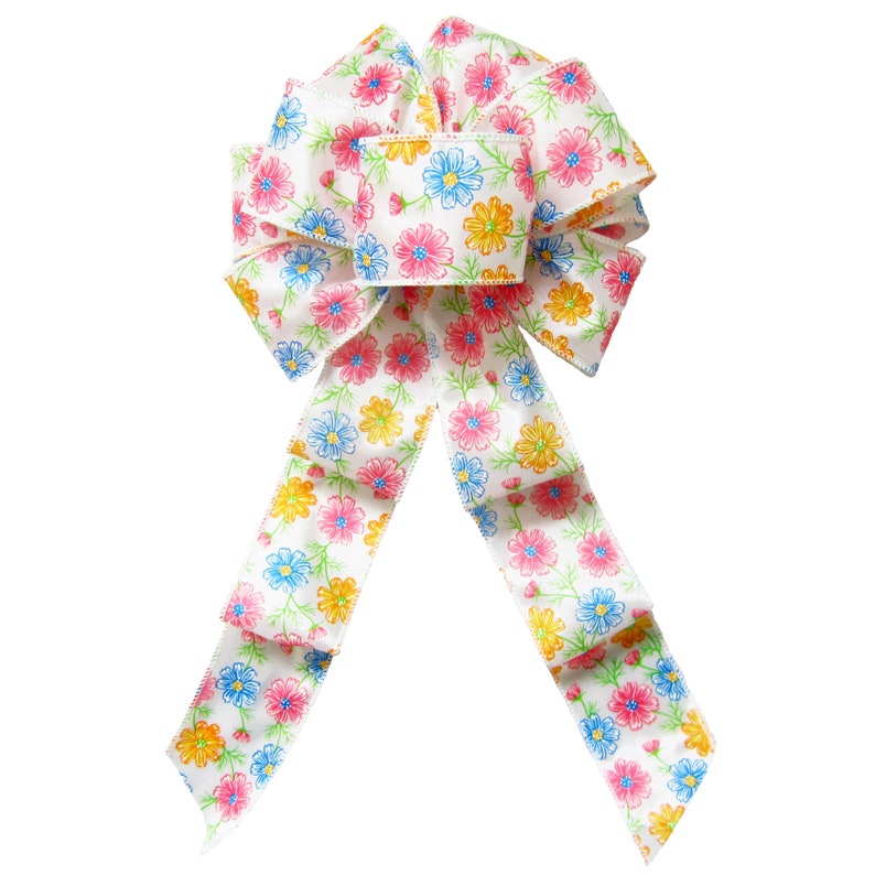 May include: A white satin bow with a floral print featuring pink, blue, and yellow flowers. The bow is tied in a classic shape with two long tails.