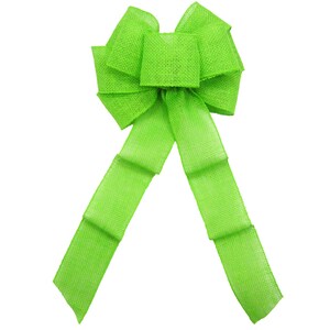 May include: A large, bright green burlap bow with a center loop and long tails. The bow is made of a textured fabric and is perfect for adding a touch of color and whimsy to any decor.