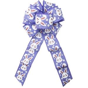 May include: A large Easter bow in periwinkle and white. The bow features a repeating pattern of smiling bunny faces and small white flowers. The bunny ears have a glittery, pink finish. The bow is made of a textured ribbon.
