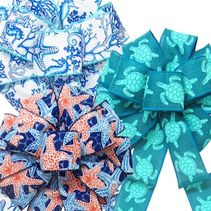 May include: Three different ribbon designs featuring a nautical theme. The first ribbon is white with blue seahorses and coral. The second ribbon is blue with turquoise sea turtles. The third ribbon is blue with orange starfish.