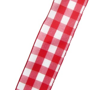 May include: Red and white gingham ribbon with a white background and red squares. The ribbon has a slightly frayed edge.