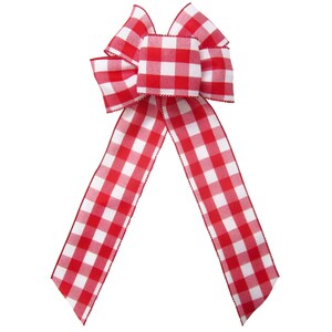 May include: A red and white gingham bow with a large center loop. The bow is made of a soft, textured fabric.