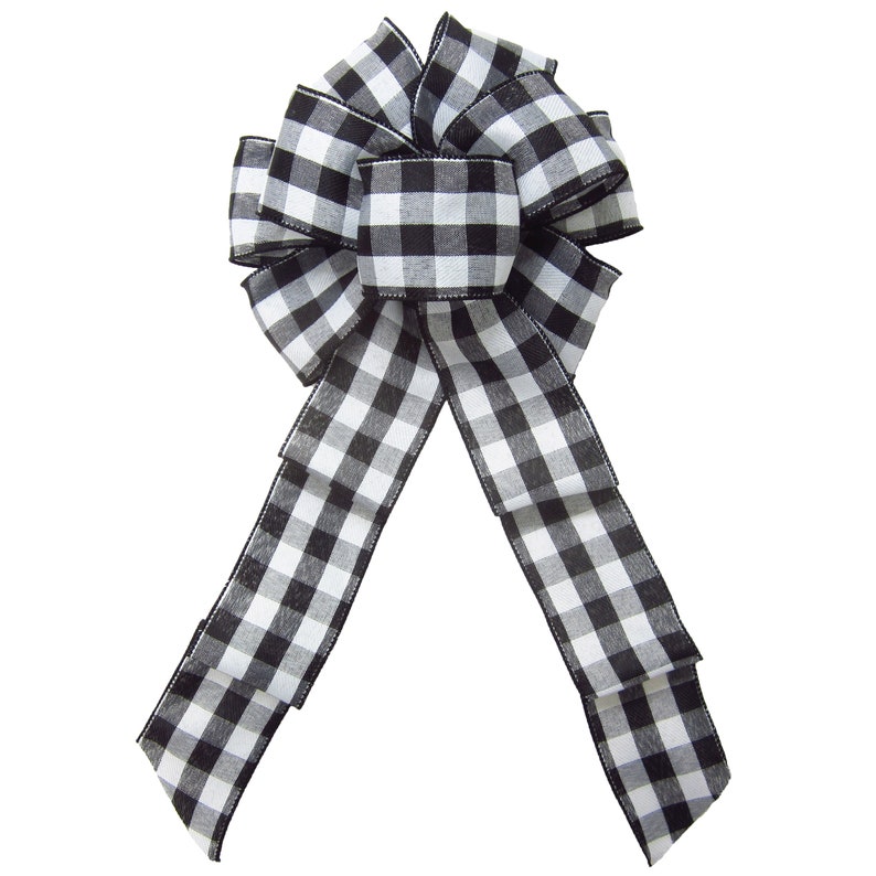 May include: A black and white checkered bow with a long tail. The bow is made of a soft, woven fabric and is perfect for adding a touch of farmhouse style to any decor.