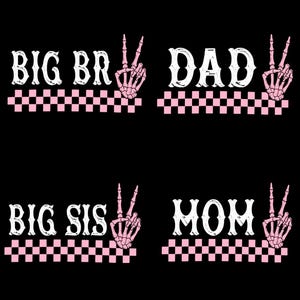 May include: Black graphic design with the words "BIG BR", "DAD", "BIG SIS", and "MOM" in white, decorative font. Each word has a pink skeleton hand in a peace sign, and a pink and white checkered pattern.
