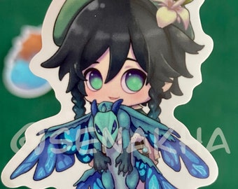 May include: A sticker featuring a cartoon character with green hair and a green hat holding a blue and green dragon with wings. The dragon has a light blue and green color scheme.
