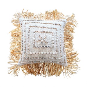 Cushion cover with shells and raffia fringe