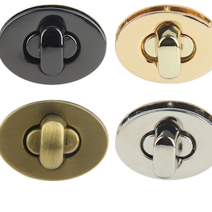 May include: Four different coloured metal clasps for bags or purses. The clasps are oval shaped with a decorative, raised, clover-shaped design in the centre. The clasps are black, gold, brass, and silver.
