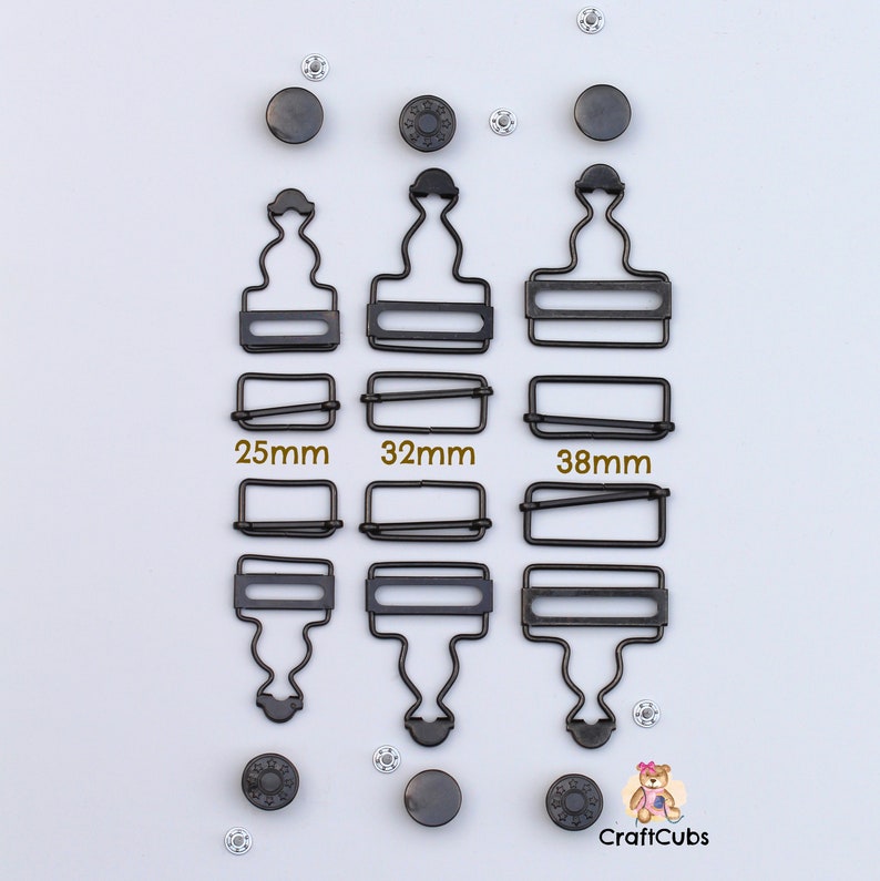 May include: Three sets of black metal clasps with different sizes: 25mm, 32mm, and 38mm. Each set includes a top and bottom piece. The clasps are designed for attaching garments or other items.