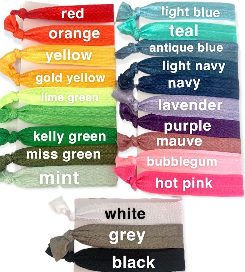 May include: A set of 18 colorful hair ties in various shades of red, orange, yellow, green, blue, purple, pink, and white. The hair ties are arranged in rows with the color name printed below each one.