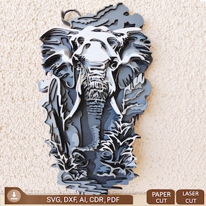 May include: A layered, 3D design of an elephant standing in a jungle setting. The elephant is made of wood and has a grey and white colour scheme. The design is suitable for laser cutting or paper cutting.