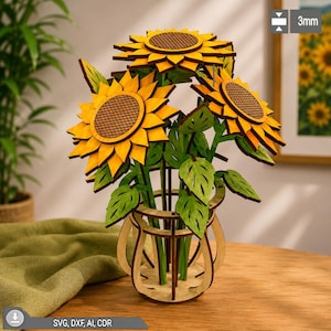 Pode incluir: Um buquê de girassóis de madeira cortado a laser em um vaso correspondente, com três flores amarelas com centros marrons e folhas verdes. A estrutura é feita de material de 3 mm de espessura, conforme indicado no texto da imagem.