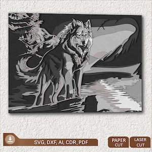 May include: A black and white layered paper cut design of a wolf standing on a rock by a lake with a mountain in the background.