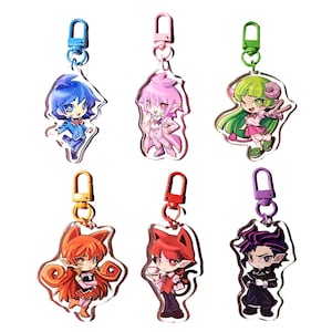 May include: Six acrylic keychains featuring anime-style characters with distinct color schemes. The characters have varied hair colors including blue, pink, green, orange, red, and dark purple, each attached to a matching colored plastic lobster clasp.