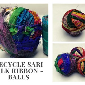 Purple and green sari silk ribbon ball beside smaller multicolored ribbon balls