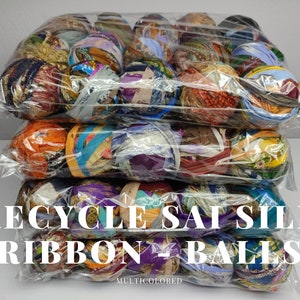 Rows of packaged assorted sari silk ribbon balls showing varied prints and colors