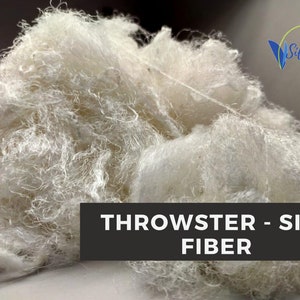 Close view of white throwster silk waste fiber prepared for spinning, blending and dyeing.