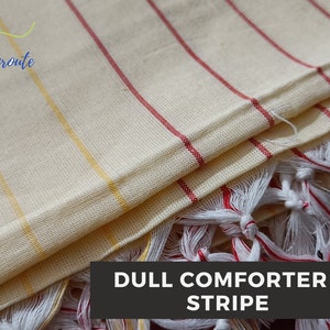 May include: A cream-colored striped throw blanket with red and yellow stripes. The blanket has white fringe on the edges and the text "DULL COMFORTER - STRIPE" is printed on the bottom.