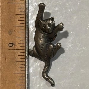 Assorted Vintage and contemporary black/ gray cat brooches/ pins/ book mark