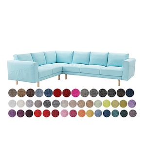May include: A light blue sectional sofa with wooden legs. The sofa has multiple cushions and armrests. Below the sofa are fabric color swatches in various shades of brown, gray, red, pink, and blue.