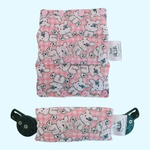 May include: Pink and white fabric strap with a white bear print and the name "Lylah" embroidered on it. The strap has two adjustable buckles and a white label that says "Boogie & Bear Car Covers".
