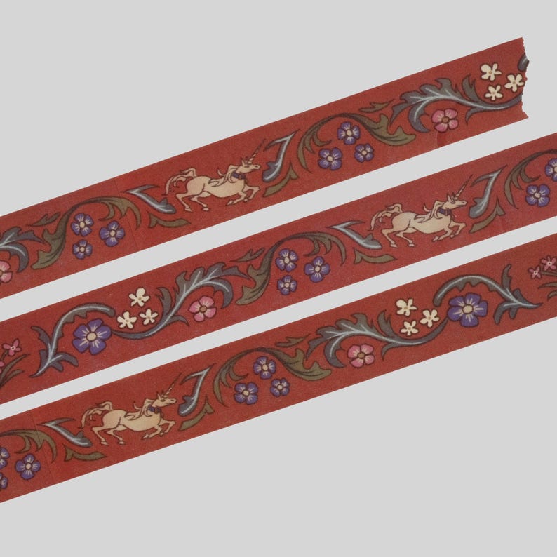 May include: Three strips of red decorative tape featuring a repeating pattern of cream-colored unicorns, dark green scrolling foliage, and small clusters of purple and pink flowers. The design is printed in a continuous, flat, and linear format.