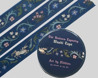 May include: A roll of dark blue washi tape labeled The Unicorn Tapestry Washi Tape Art by Elithien 15 mm x 10 m. The tape features a repeating pattern of white unicorns, green vines, and small pink and blue flowers on a dark blue background.