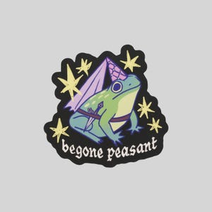 May include: A sticker featuring a cartoon frog wearing a party hat, wings, and a sword. The frog is green and blue, with a purple and pink hat and wings. The sticker has the text "begone peasant" in white, with yellow star accents on a black background.