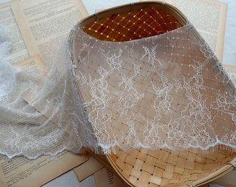 May include: White lace trim with a delicate floral pattern, displayed on a woven basket.