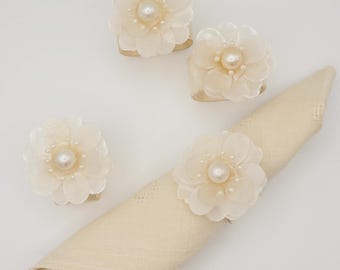 Mother-of-pearl napkin ring set with delicate pearl flowers