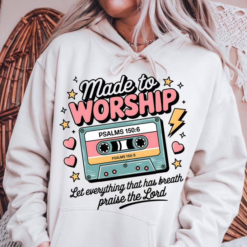 May include: A white hoodie with a pink and blue cassette tape graphic. The text on the hoodie reads "Made to Worship" and "Let everything that has breath praise the Lord".