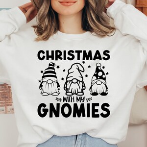 May include: White sweatshirt with black text that reads "Christmas with my Gnomies" and three black and white gnome illustrations.