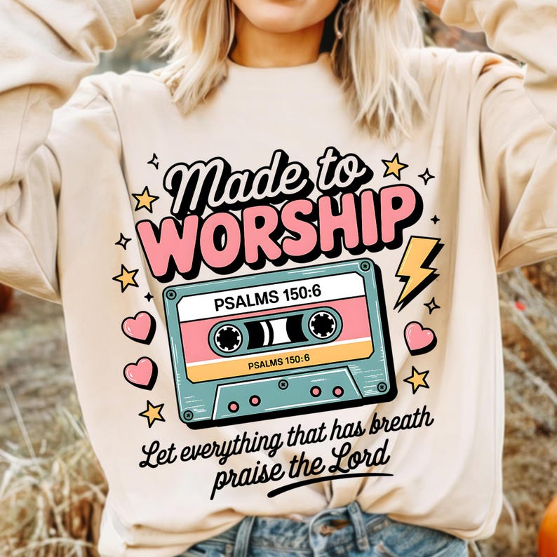 May include: A beige sweatshirt with a pink and blue cassette tape graphic. The text "Made to Worship" is above the cassette tape and the text "PSALMS 150:6" is on the cassette tape. The text "Let everything that has breath praise the Lord" is below the cassette tape.