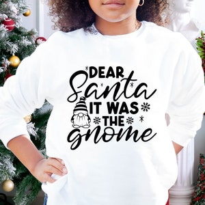 May include: White sweatshirt with a black graphic that says "Dear Santa It Was The Gnome" with a small gnome illustration.