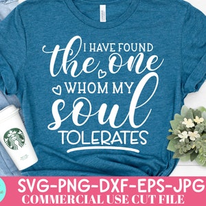 May include: Teal t-shirt with the text "I HAVE FOUND the ONE WHOM MY SOUL TOLERATES" in white script. A coffee cup and a small floral arrangement are visible. The shirt is folded, and the words "SVG-PNG-DXF-EPS-JPG COMMERCIAL USE CUT FILE" are at the bottom.