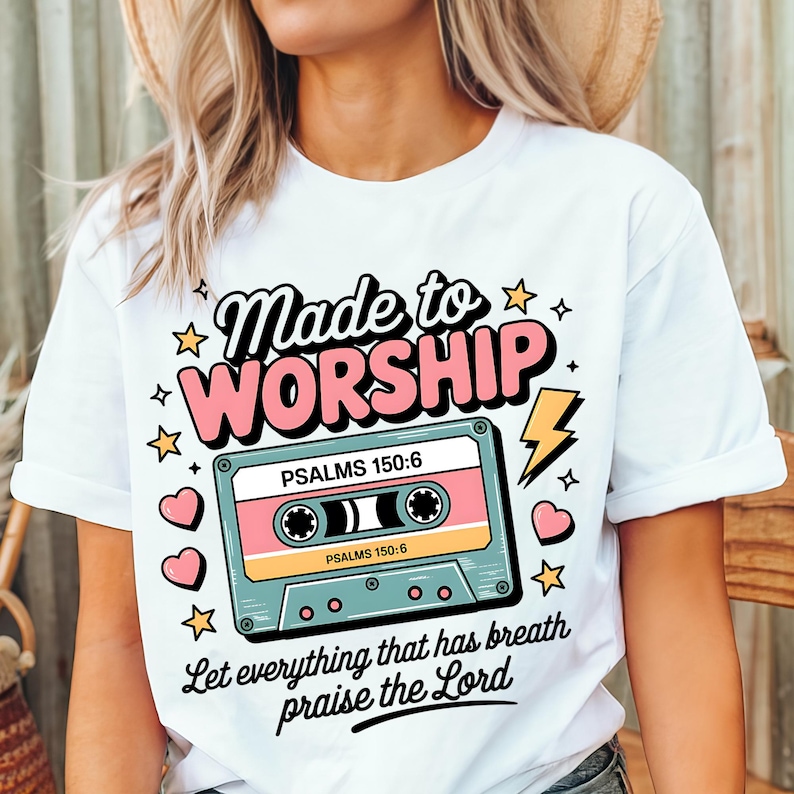 May include: White t-shirt with a pink and blue cassette tape graphic. The text "Made to Worship" is above the cassette tape and the text "PSALMS 150:6" is on the cassette tape. The text "Let everything that has breath praise the Lord" is below the cassette tape.