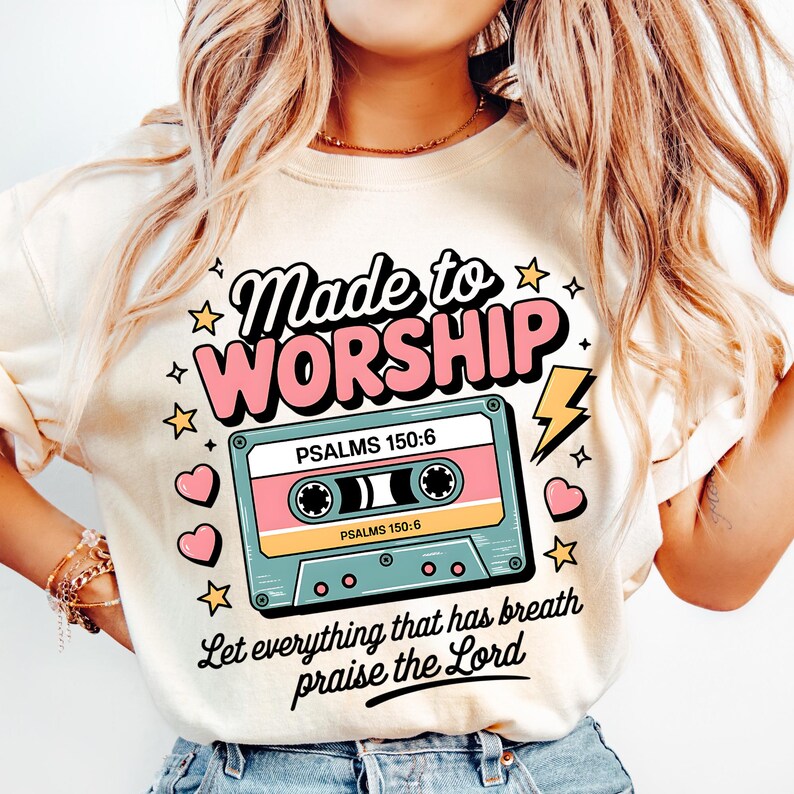 May include: A cream-colored t-shirt with a retro-style design featuring a cassette tape and the text "Made to Worship" with the Bible verse "Psalms 150:6" and the phrase "Let everything that has breath praise the Lord".