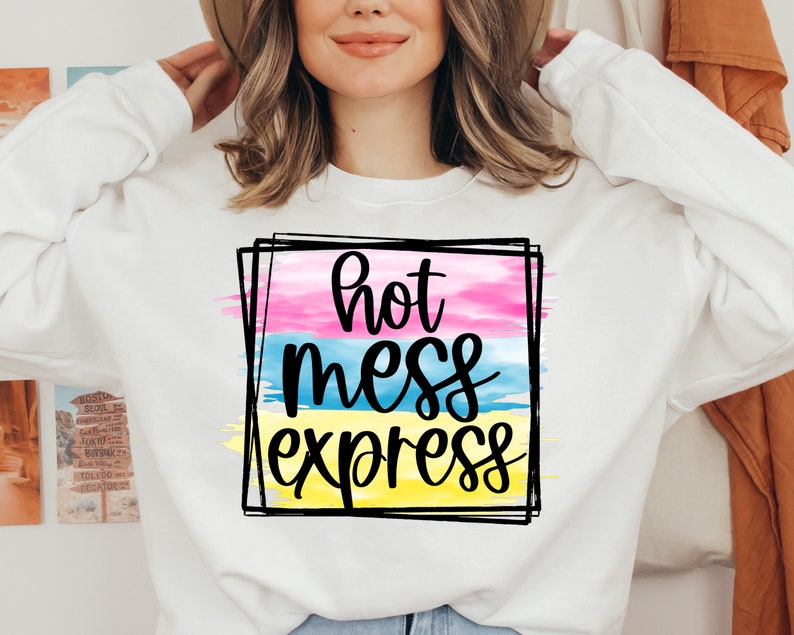 May include: White sweatshirt with a graphic design of a colorful watercolor background with the text "hot mess express" in black.