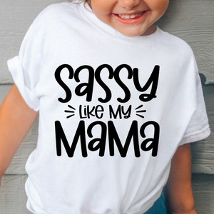May include: White t-shirt with black text that reads "Sassy Like My Mama".
