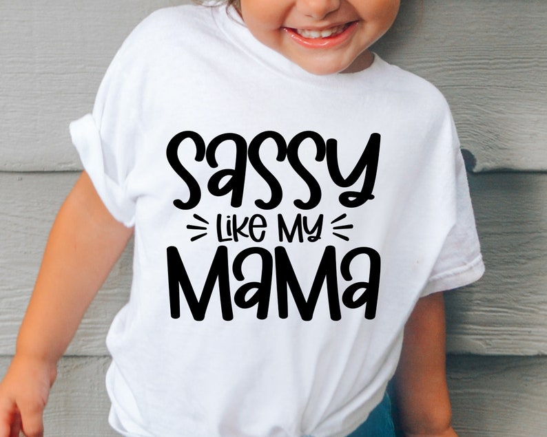 May include: White t-shirt with black text that reads "Sassy Like My Mama".