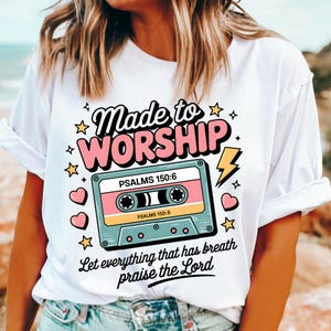 May include: White t-shirt with a pink and blue cassette tape graphic. The text "Made to Worship" is above the tape and "Let everything that has breath praise the Lord" is below the tape. The text "Psalms 150:6" is on the tape.