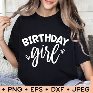 May include: A black t-shirt with the text "Birthday girl" in white lettering with two small hearts on either side of the word "girl".
