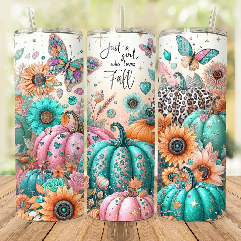May include: A tumbler with a design featuring pumpkins, butterflies, sunflowers, and the text "Just a girl who loves Fall". The design is in shades of pink, teal, orange, and gold.
