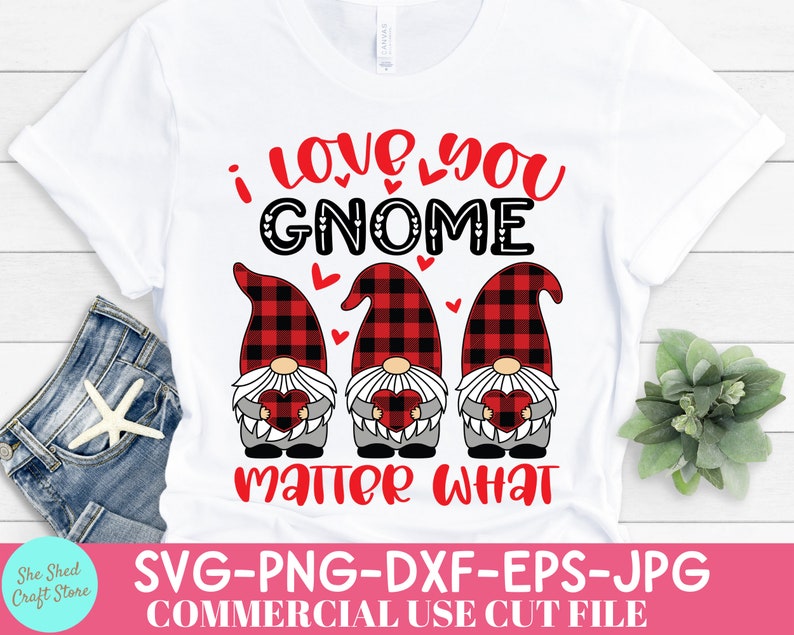 May include: White t-shirt with the text "I love you GNOME matter what" in red and black. Three gnomes with buffalo plaid hats and hearts are featured in the design. The shirt is a commercial use cut file.