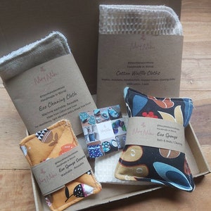 May include: A set of eco-friendly cleaning and bath products in a cardboard box. The set includes a cotton waffle cloth, a reusable eco cleaning cloth, an eco sponge scourer, and an eco sponge for bath and body. The products are handmade in Wirral.