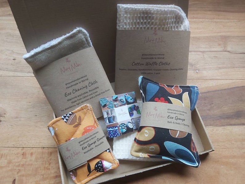 May include: A set of eco-friendly cleaning and bath products in a cardboard box. The set includes a cotton waffle cloth, a reusable eco cleaning cloth, an eco sponge scourer, and an eco sponge for bath and body. The products are handmade in Wirral.