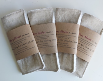 May include: Four beige and white eco-friendly cleaning cloths with brown paper labels that read "Mary Makes Zero Waste" and "Duty Eco Cleaning Cloth". The labels also include information about the product being washable, reusable, and made from cotton and linen.