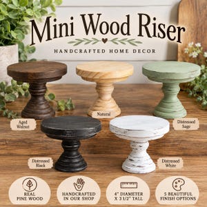 May include: Five mini wood risers with a 4-inch diameter and 3.5-inch height, featuring a pedestal base. The set includes finishes in aged walnut, natural, distressed sage, distressed black, and distressed white. Each stand is made of pine wood.