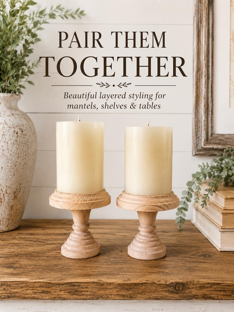 May include: Two ivory pillar candles sit atop light wood candle holders. The holders have a decorative, turned design. The image includes the text "PAIR THEM TOGETHER" and "Beautiful layered styling for mantels, shelves & tables."